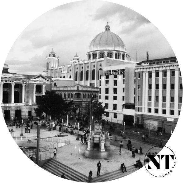 Aerial view of San Salvador with its modern skyline and the iconic volcano in the background.